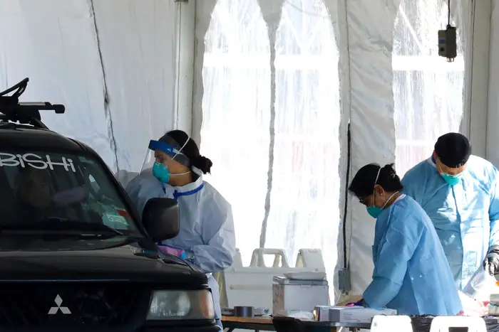 Healthcare workers test people for coronavirus Covid-19 at the drive up testing site at Lehman College in the Bronx, New York, USA, 15 April 2020.